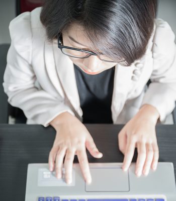 Young woman working on laptop Realtime Reporting
